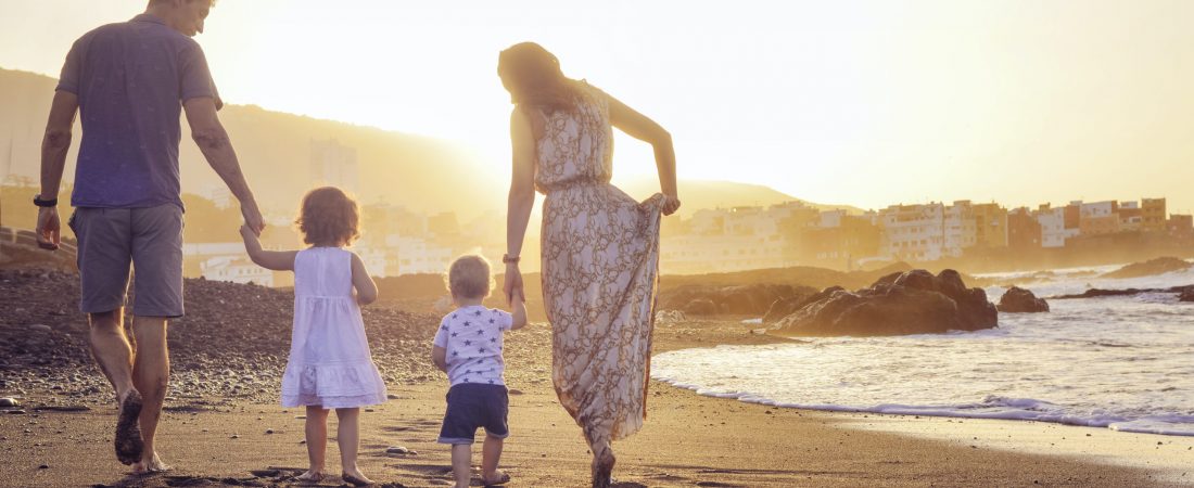 Relaxed family on vacation watching a beautiful sunset