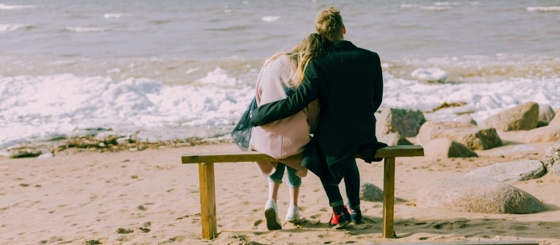 man-and-woman-hugging-and-sitting-on-a-bench-698882